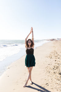 Young girl in dress enjoying a vacation near the summer sea of italy