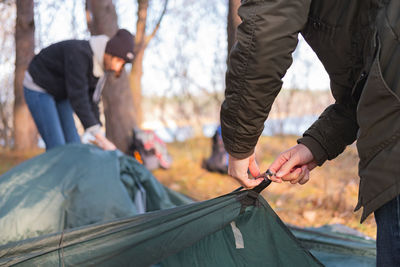 Couple making tent at campsite