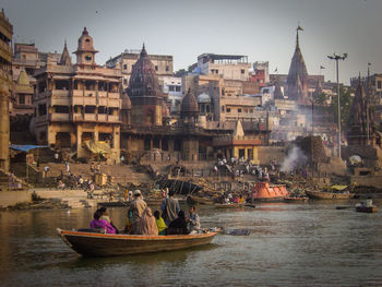 People in temple against sky in city