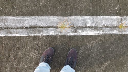 Low section of man standing on street