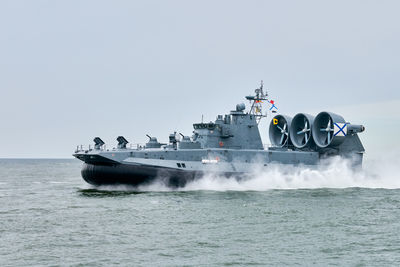 Boats in sea against clear sky