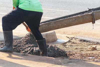 Low section of man working on road