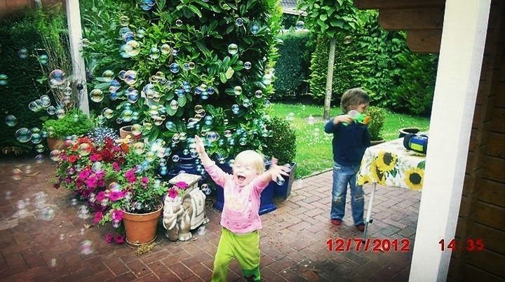 lifestyles, leisure activity, full length, casual clothing, tree, human representation, park - man made space, flower, person, statue, standing, plant, day, sitting, childhood, art, outdoors