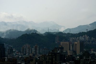 Cityscape with mountain range in background