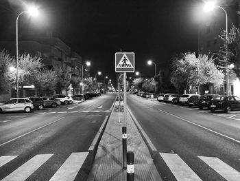 Illuminated road sign at night