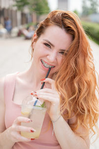 Young woman drinking glass