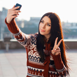 Portrait of beautiful young woman using mobile phone