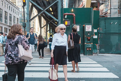 Women walking on street in city