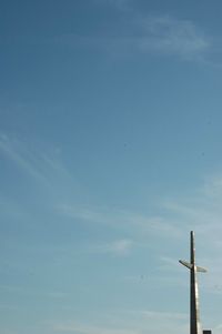 Low angle view of pole against blue sky