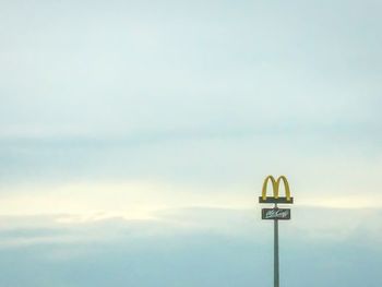 Low angle view of information sign against sky