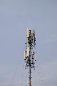 Low angle view of communications tower against sky