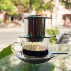 Drip black coffee in vietnamese style with condensed milk on a glass. method of making coffee.