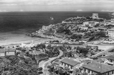 High angle view of townscape by sea against sky