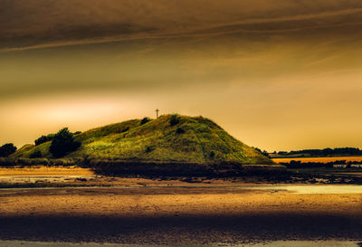 Scenic view of beach against sky during sunset