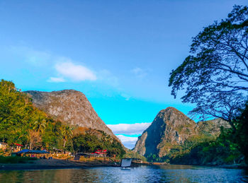 Scenic view of sea and mountains against sky