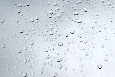 Full frame shot of raindrops on glass window