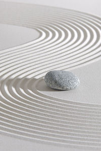 Japanese zen garden with stone in textured sand