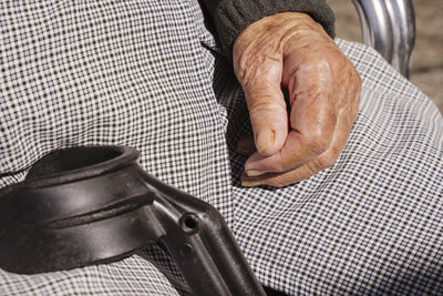 Midsection of disabled woman sitting on wheelchair