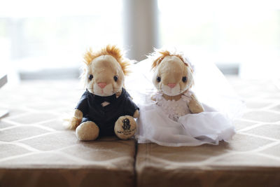 Close-up of stuffed toys on bed at home