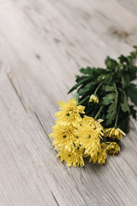 Close-up of yellow flowers on table