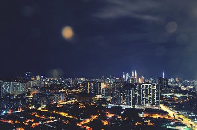 High angle view of illuminated city buildings at night