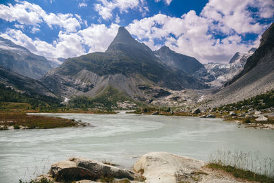 Scenic view of lake and mountains against sky