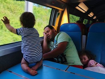 Children and father in train