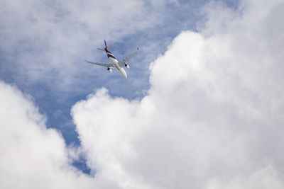 Low angle view of airplane flying in sky