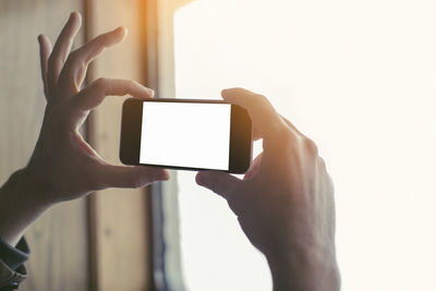 Midsection of man using mobile phone