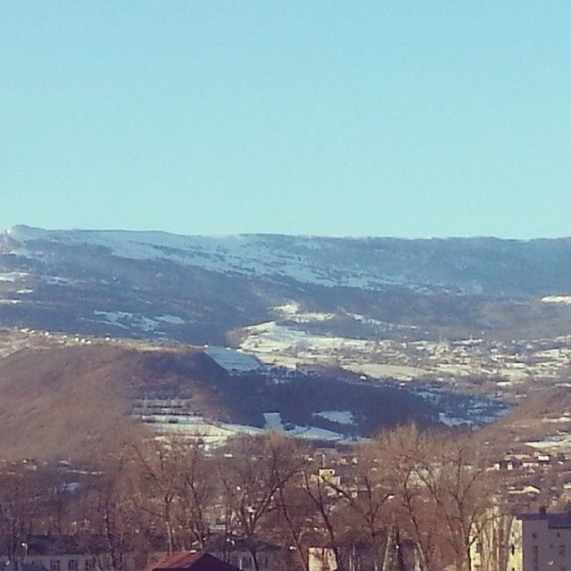 clear sky, mountain, copy space, scenics, landscape, tranquil scene, tranquility, blue, beauty in nature, mountain range, nature, high angle view, built structure, building exterior, architecture, day, idyllic, outdoors, winter, non-urban scene