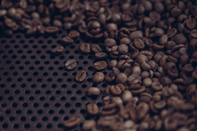 High angle view of roasted coffee beans on metal