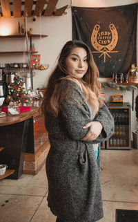 Portrait of smiling woman standing at home