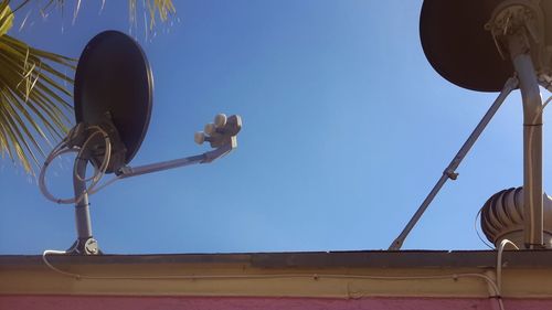 Low angle view of street light against blue sky