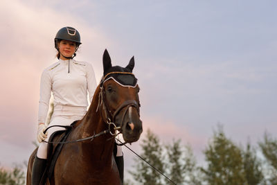 Portrait of man riding horse against clear sky