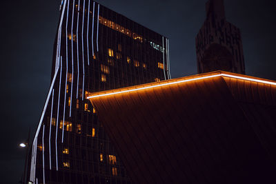 Low angle view of illuminated building against sky at night