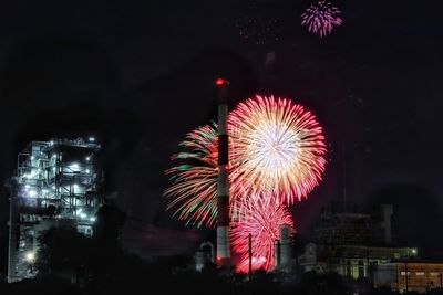 Firework display in city at night