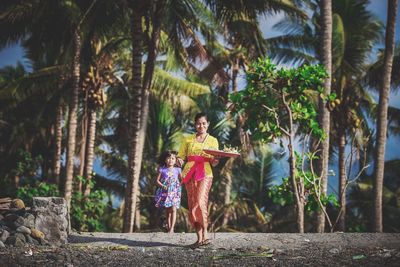 Children playing on palm tree