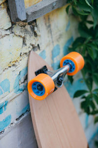 Close-up of skateboard against wall