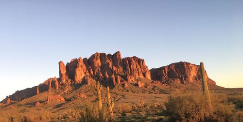 Rock formations on landscape against clear sky