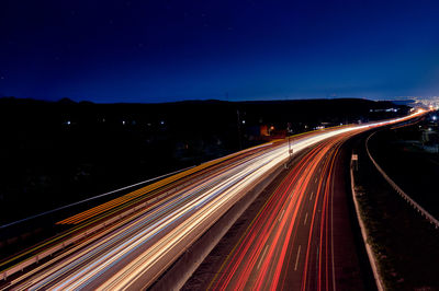 High angle view of light trails on road at night