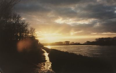 Scenic view of river against sky during sunset