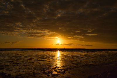 Scenic view of sea against romantic sky at sunset