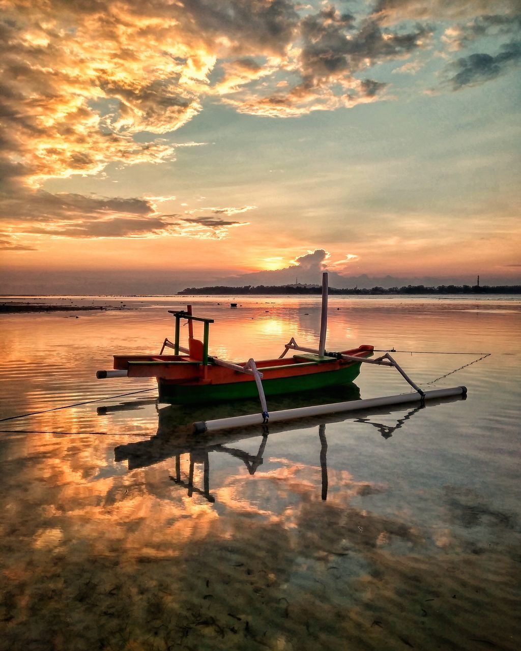 sunset, water, tranquility, sky, nautical vessel, beauty in nature, nature, scenics, orange color, tranquil scene, transportation, moored, cloud - sky, mode of transport, sea, no people, silhouette, outdoors, beach, horizon over water, outrigger, day