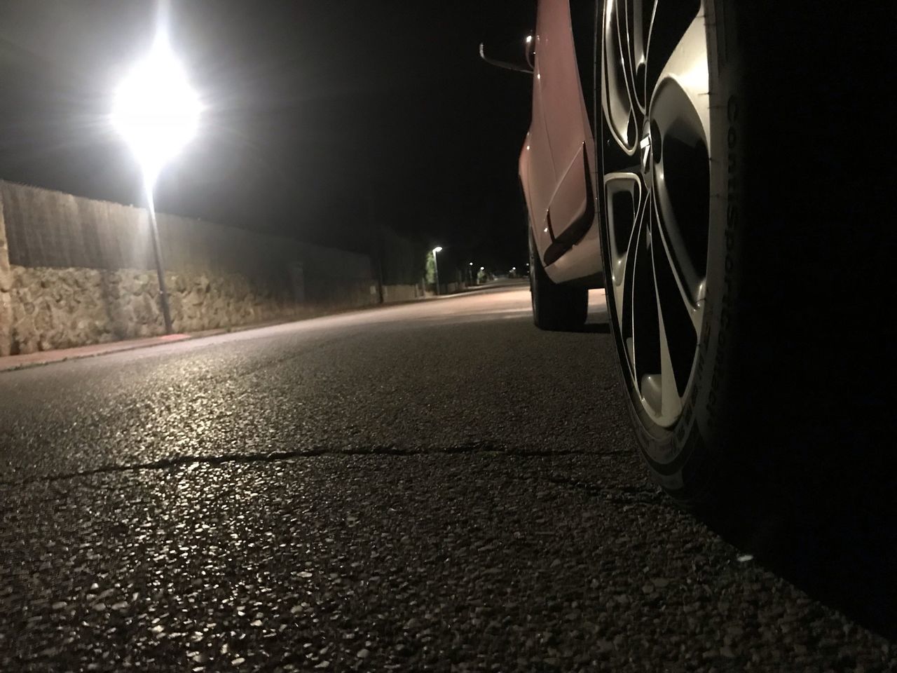 LOW SECTION OF ILLUMINATED STREET AT NIGHT