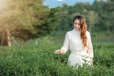 Young woman standing on field