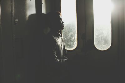 Woman looking through window