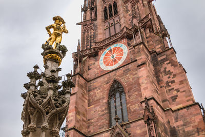 Low angle view of clock tower against building