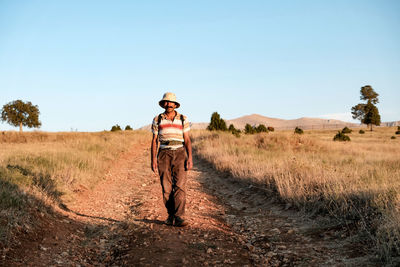 Full length portrait of man walking on field