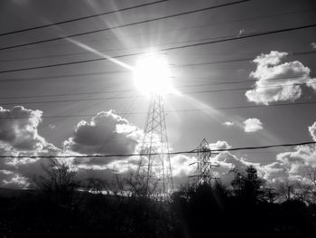 Low angle view of silhouette trees against sky