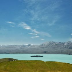 Scenic view of lake and mountains against sky